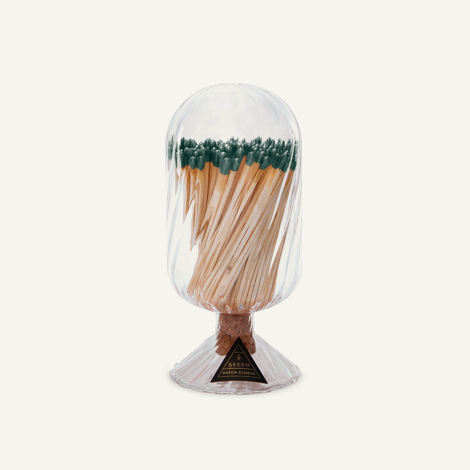 Skeem Helix Match Cloche with evergreen-tipped matches visible through hand-blown glass, cork stopper, and a fluted base